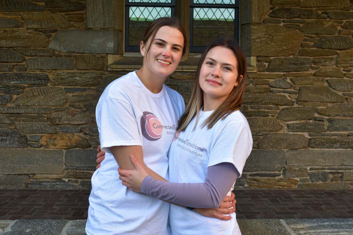 Emma and Carolyn wearing connected transitions tshirts